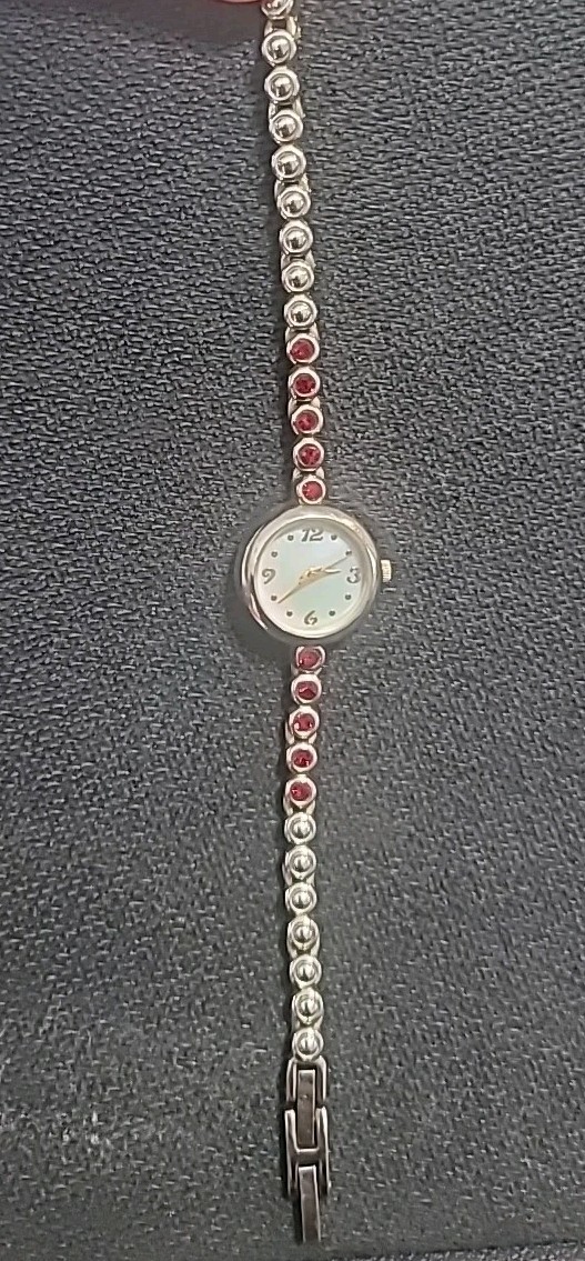 Allude Watch Women Gold Tone Mother of Pearl Dial Red Rhinestone Band Runs 7.25″