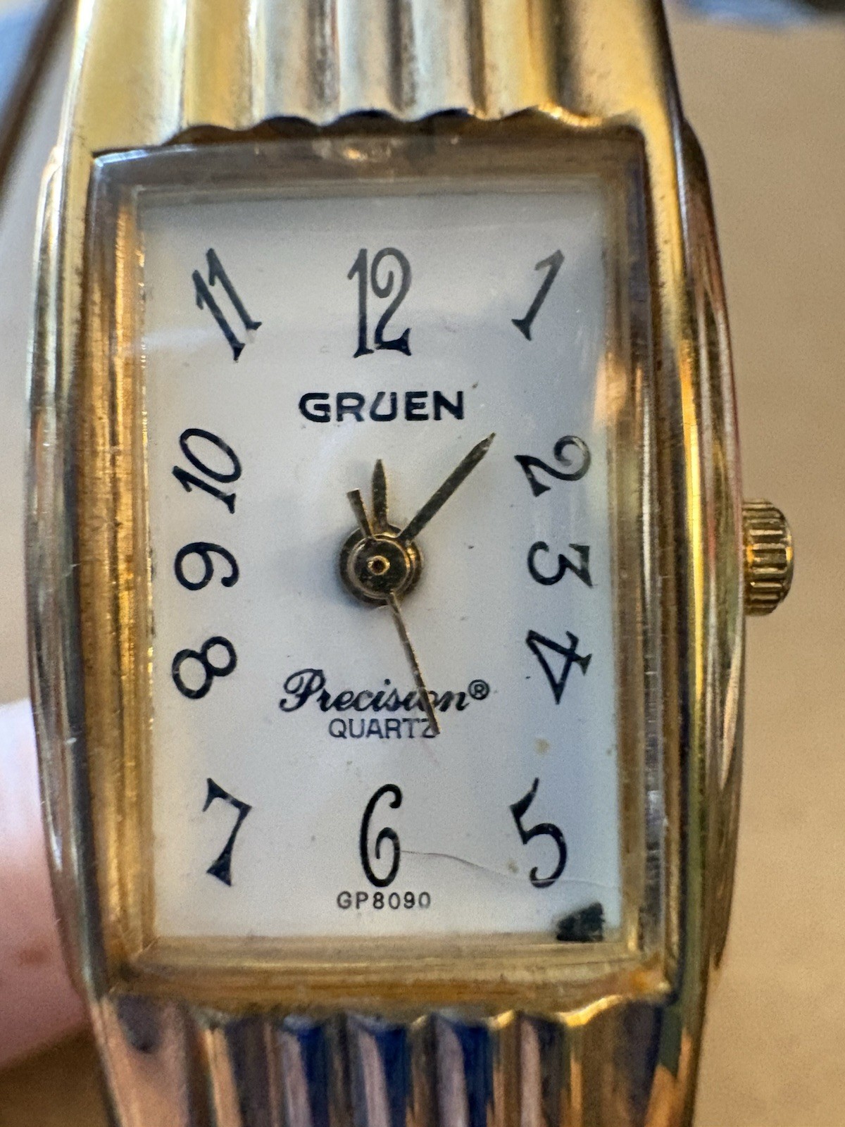 Gruen women’s Wristwatch With chunky gold-tone hinged cuff bangle.