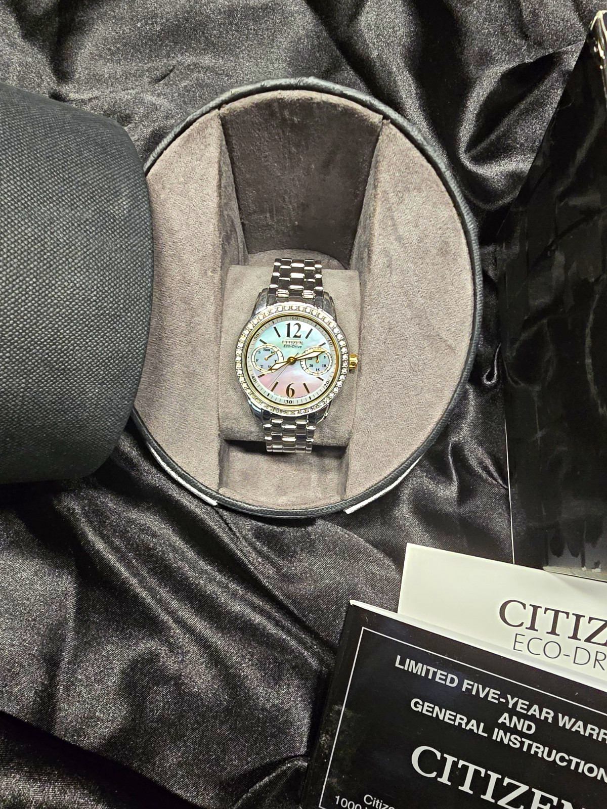 Citizen Eco-Drive Women’s MOP Dial Silver SS Bracelet Watch Day/Date Gem Bezel