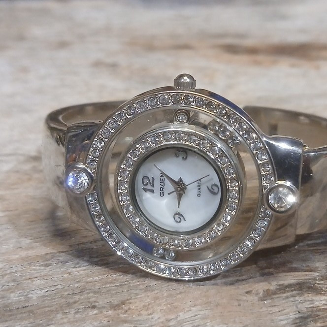 Gruen Women’s Quartz Analog Wristwatch Silver Bangle White Dial Gem-Set Bezel